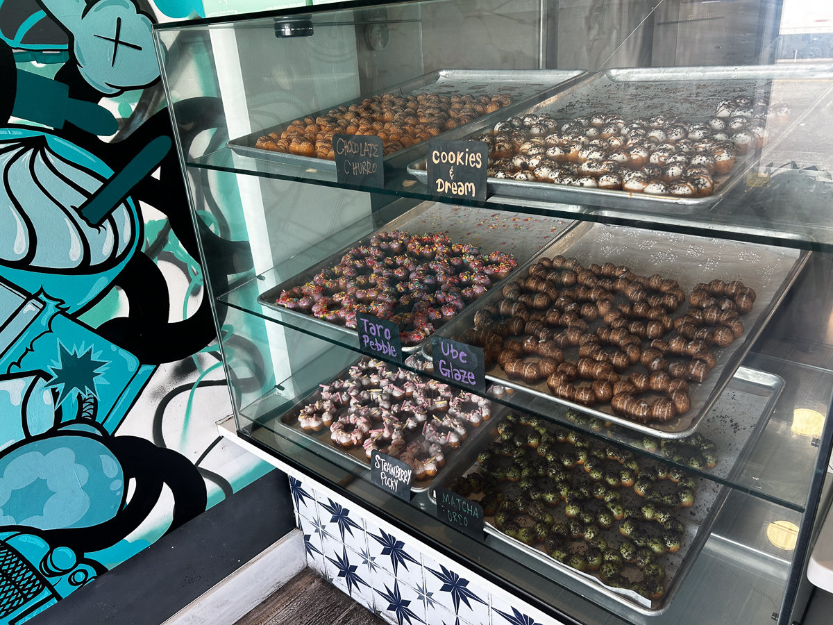 glass case with trays of dochi donuts in various flavors